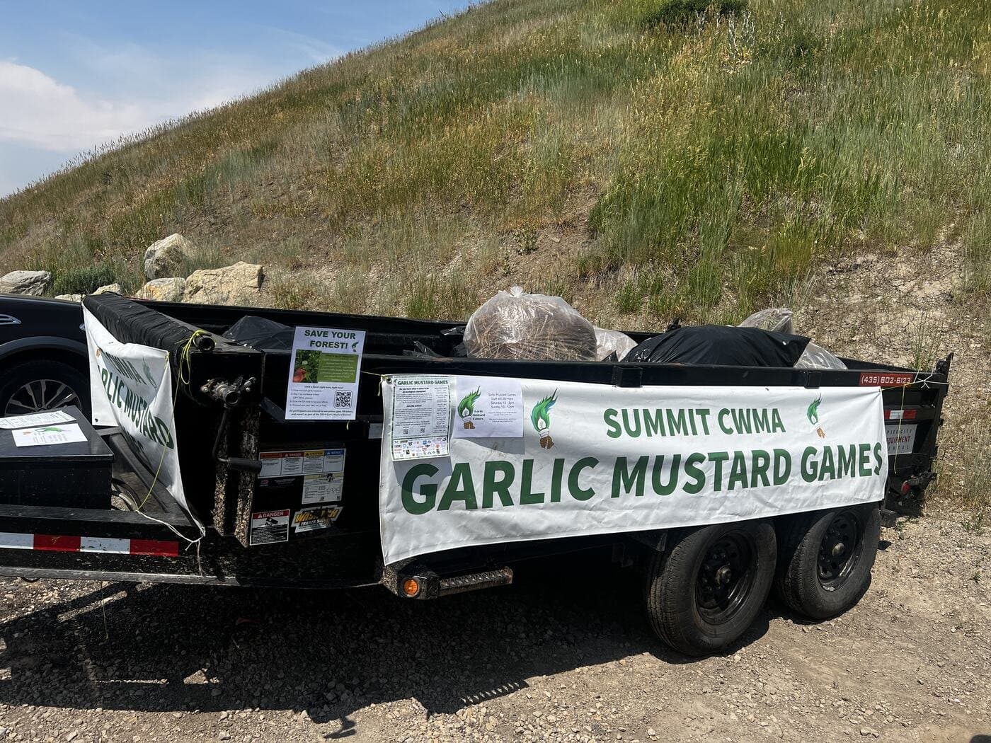 A trailer stacked with bagged garlic mustard